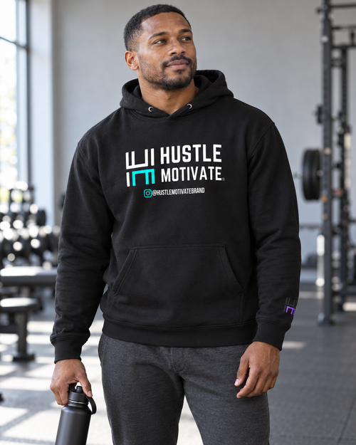 AI lifestyle mockup of the Black Hustle Motivate hoodie worn at a gym.