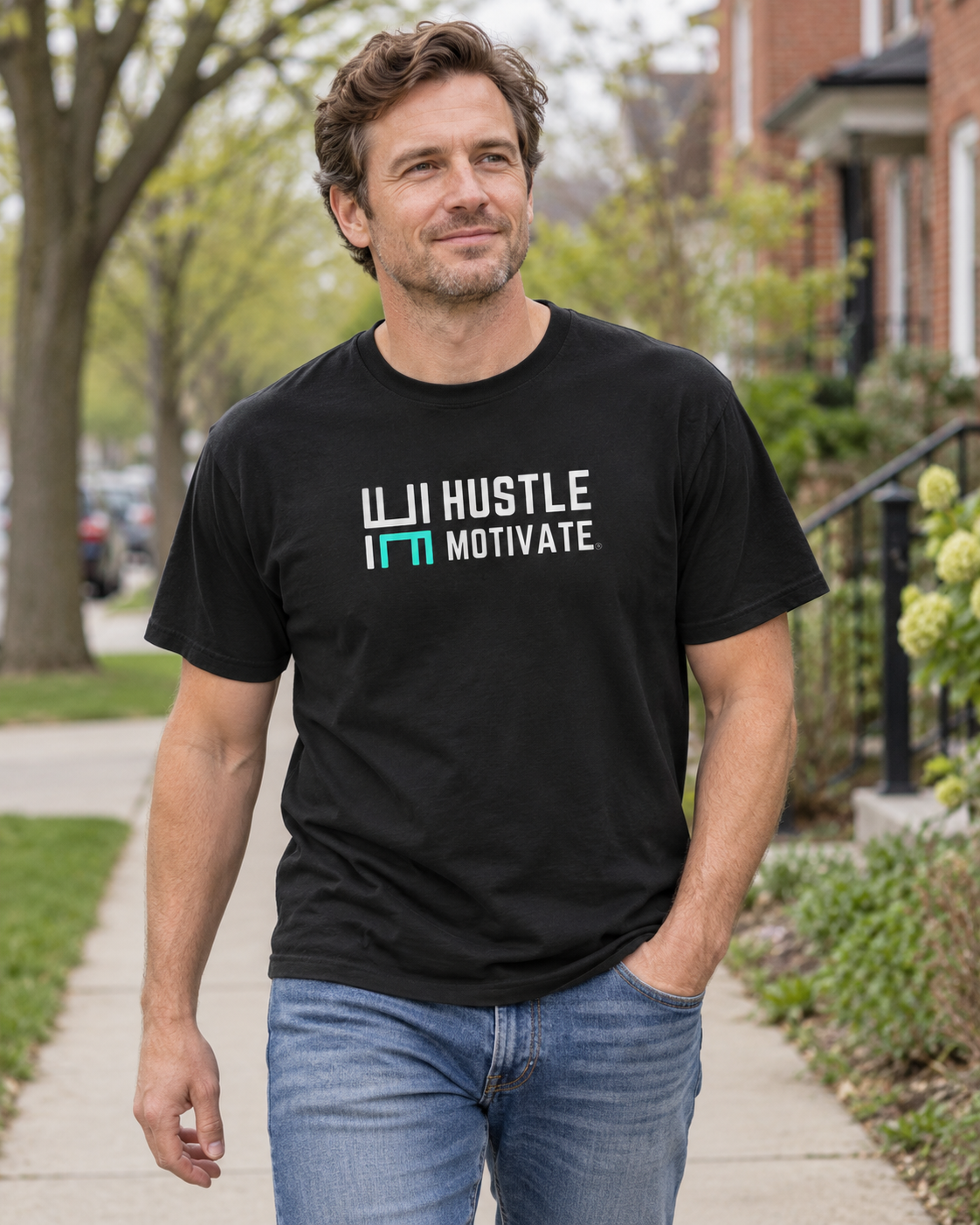 AI lifestyle mockup of the Black Hustle Motivate T-shirt worn on a neighbourhood sidewalk, showing the white-and-teal front logo.
