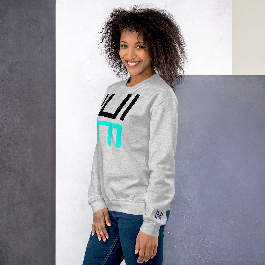 Model wearing the Hustle Motivate Statement Crewneck in ash, showing the front print and embroidered left sleeve